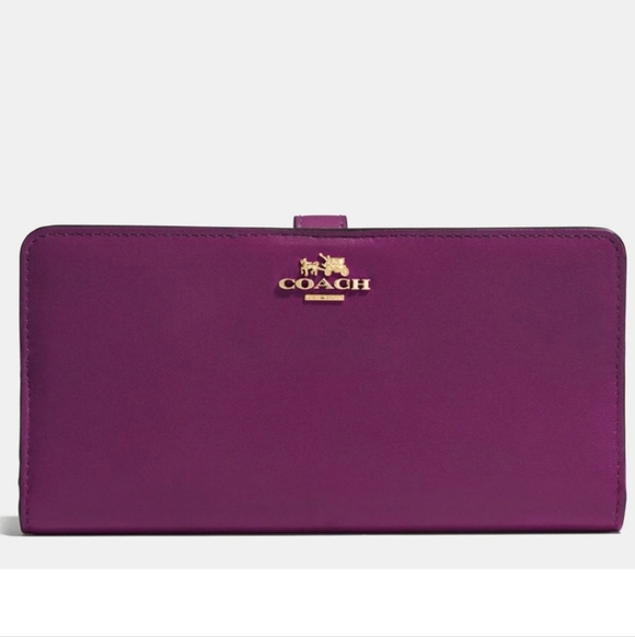 Coach Handbags - Coach Skinny Wallet in a purple/berry leather finish.